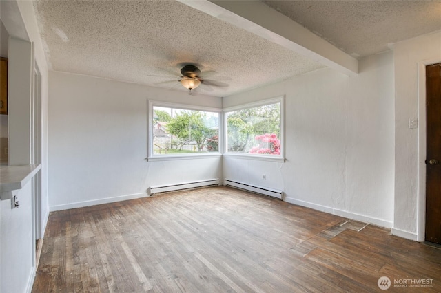 1306 Morgan St, Aberdeen, WA 98520 - unfurnished room featuring a textured ceiling, a ceiling fan, wood finished floors, baseboard heating, and baseboards