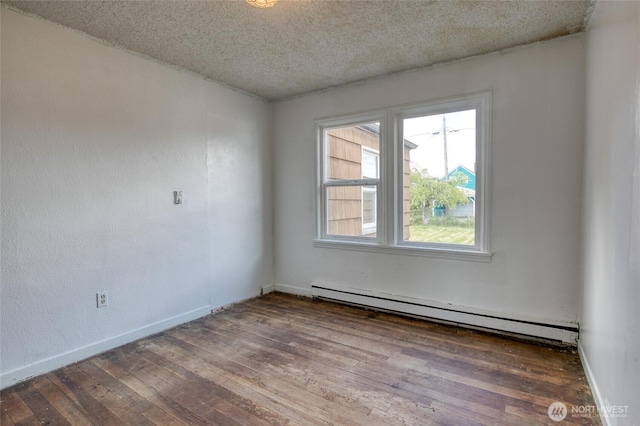 1306 Morgan St, Aberdeen, WA 98520 - unfurnished room with a baseboard radiator, wood-type flooring, a textured ceiling, and baseboards