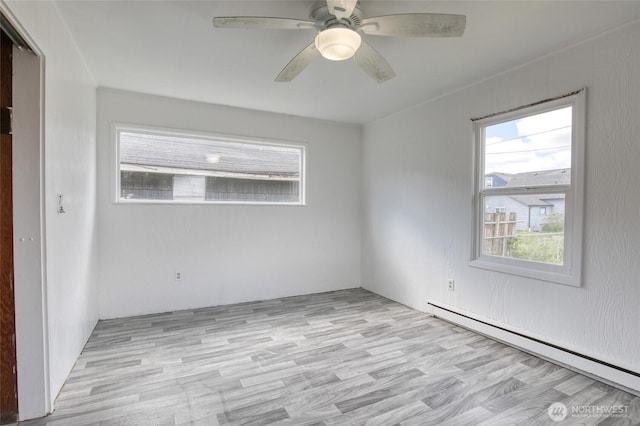 1306 Morgan St, Aberdeen, WA 98520 - unfurnished room featuring baseboard heating, ceiling fan, and light wood-type flooring