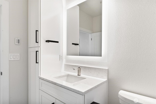 bathroom with toilet and vanity