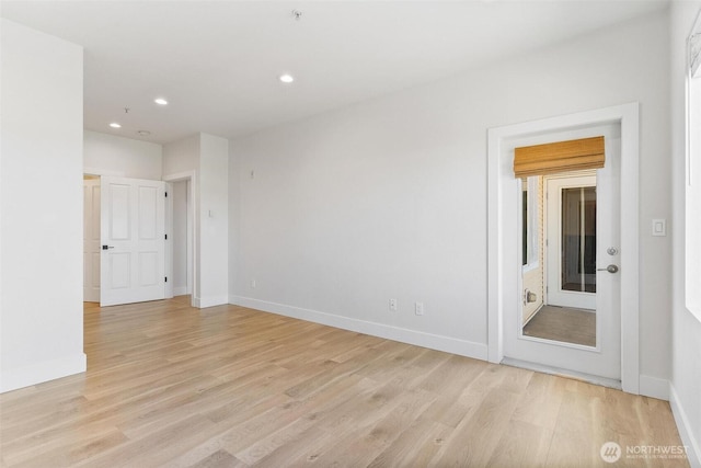 unfurnished room with light wood finished floors, recessed lighting, and baseboards