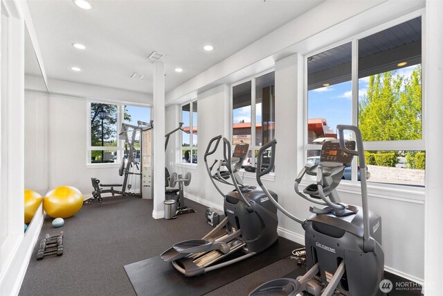 workout area featuring recessed lighting and baseboards