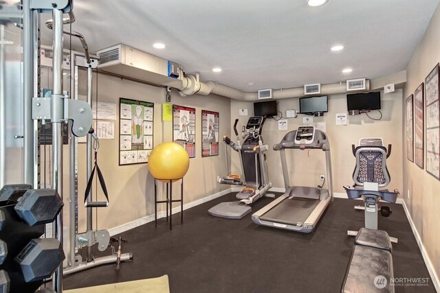exercise room featuring baseboards and recessed lighting