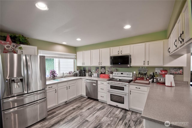 111 E Martin St, Elma, WA 98541 - kitchen featuring a sink, white cabinetry, and appliances with stainless steel finishes