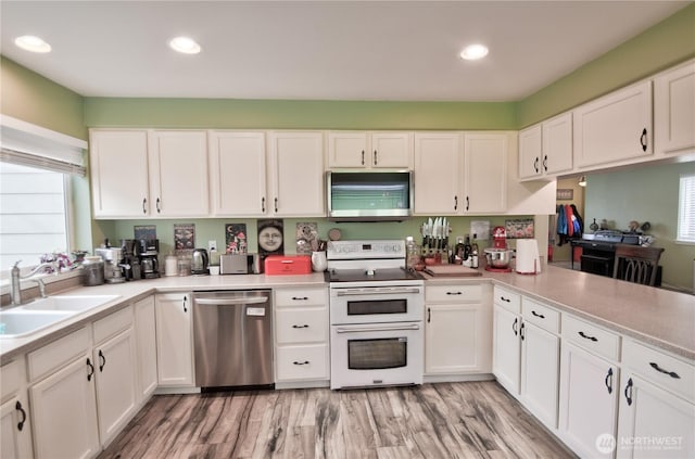111 E Martin St, Elma, WA 98541 - kitchen featuring a sink, white cabinets, and appliances with stainless steel finishes