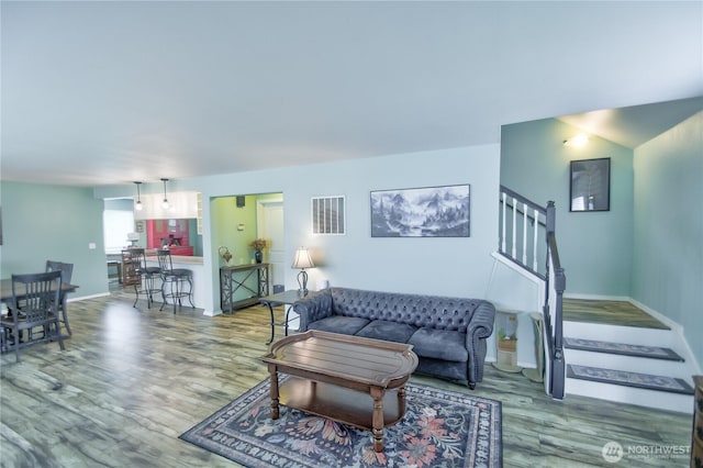 111 E Martin St, Elma, WA 98541 - living area featuring baseboards, stairway, visible vents, and wood finished floors