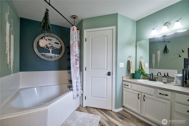 111 E Martin St, Elma, WA 98541 - bathroom with wood finished floors, a bathing tub, and vanity