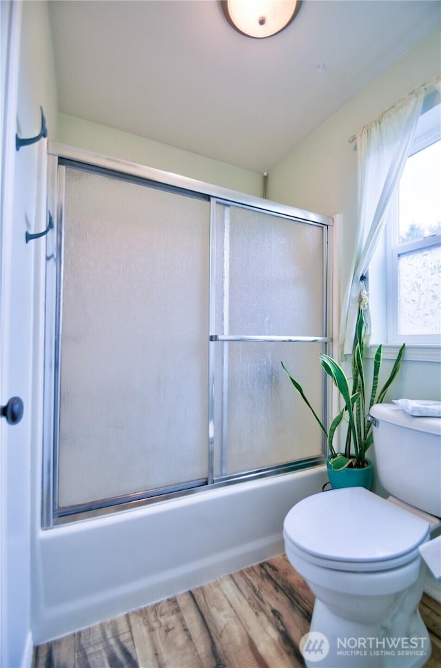 111 E Martin St, Elma, WA 98541 - full bathroom with toilet, wood finished floors, and enclosed tub / shower combo
