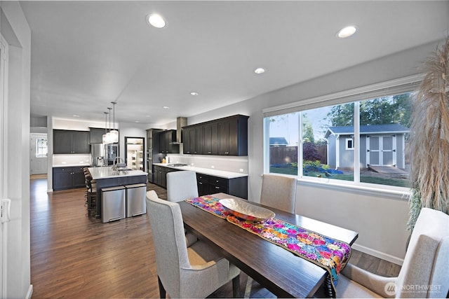 dining room featuring dark wood-type flooring, recessed lighting, and baseboards