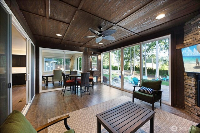 sunroom featuring wooden ceiling, healthy amount of natural light, wood finished floors, and recessed lighting