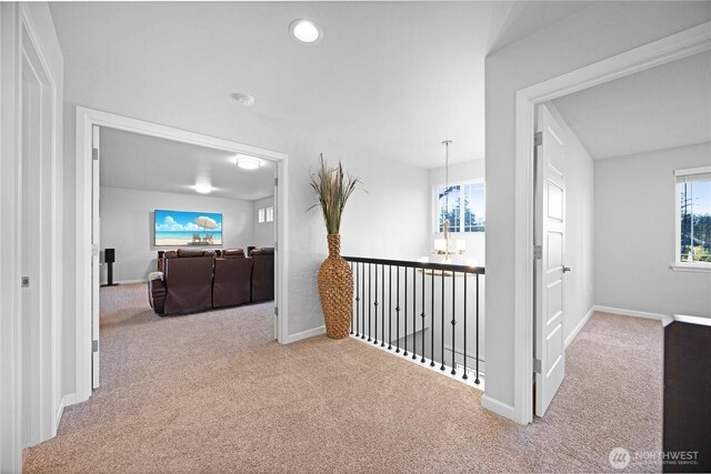 hall featuring carpet floors, baseboards, a chandelier, and recessed lighting