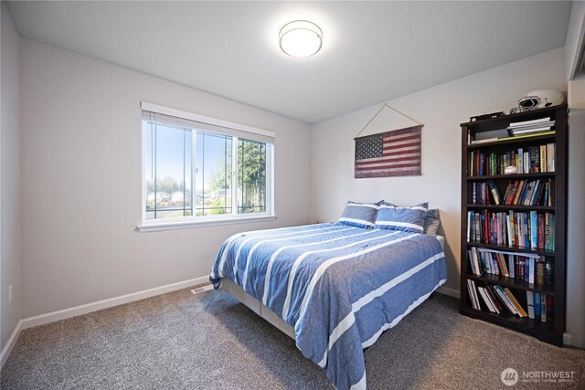 bedroom with carpet floors and baseboards