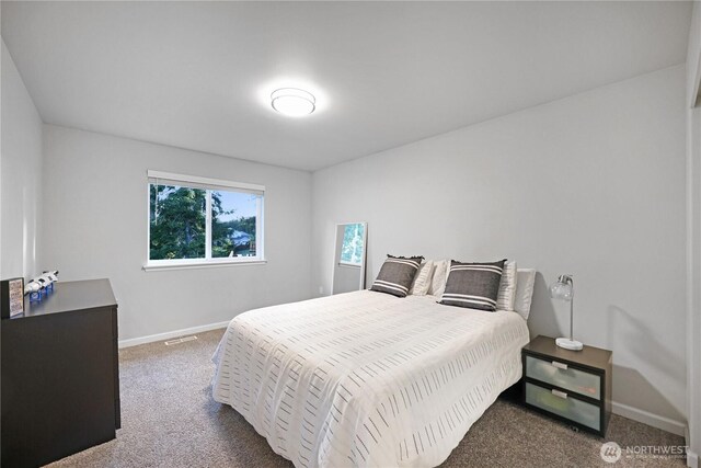 carpeted bedroom with baseboards