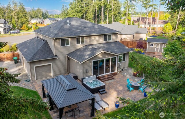 back of property with roof with shingles, fence, entry steps, a patio area, and a residential view