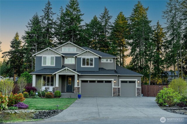 craftsman inspired home with stone siding, concrete driveway, a garage, and board and batten siding