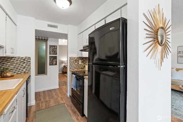 12515 NE 145th Pl Unit D121, Kirkland, WA 98034 - kitchen with black appliances, dark wood-style floors, white cabinetry, decorative backsplash, and a sink