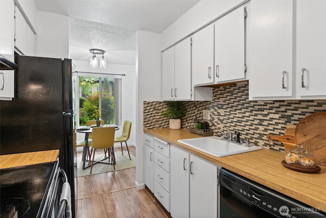 12515 NE 145th Pl Unit D121, Kirkland, WA 98034 - kitchen featuring black appliances, a sink, light countertops, white cabinetry, and decorative backsplash
