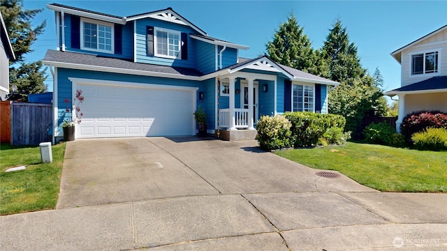 traditional home with fence, an attached garage, a front lawn, and concrete driveway