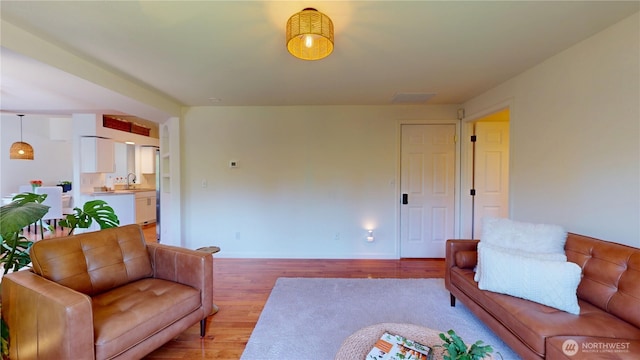 living room with light wood-style flooring and baseboards