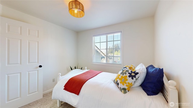 bedroom with carpet flooring and baseboards