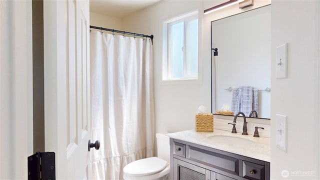 bathroom featuring toilet and vanity