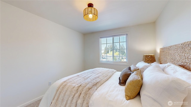 carpeted bedroom with baseboards