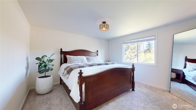 carpeted bedroom featuring baseboards
