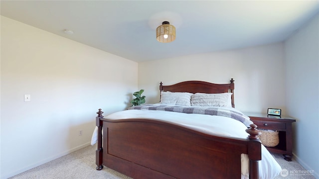 bedroom with light carpet and baseboards