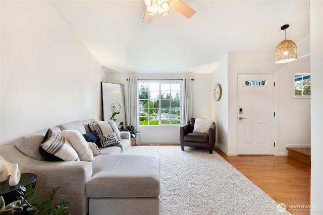 3416 189th St SE, Bothell, WA 98012 - living room with light wood-style floors, ceiling fan, baseboards, and lofted ceiling