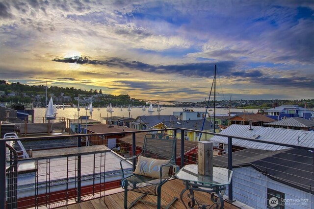 balcony at dusk featuring a residential view