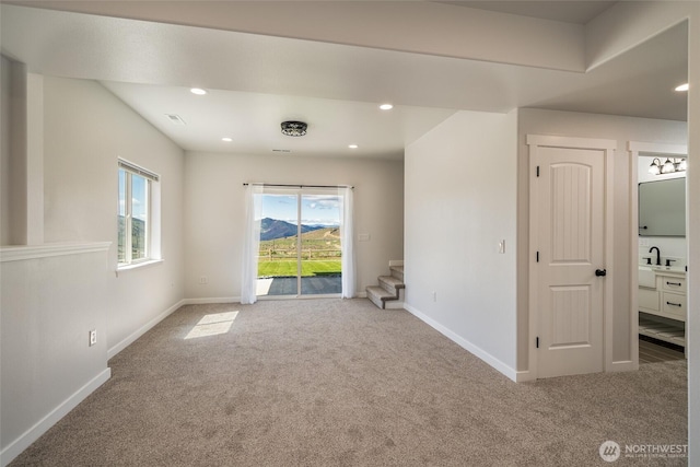 10 Spring Canyon Rd, Orondo, WA 98843 - unfurnished room featuring carpet floors, baseboards, stairway, and recessed lighting