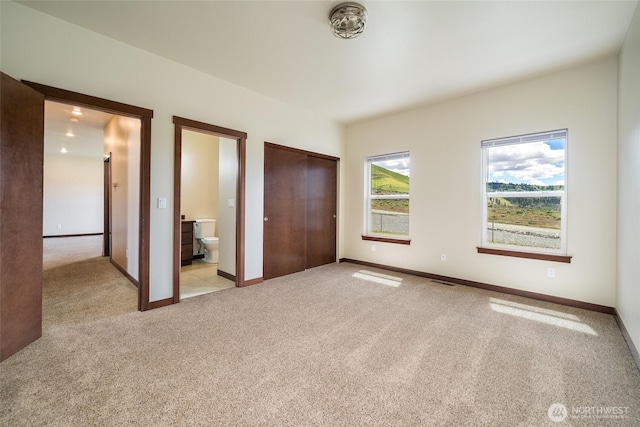 10 Spring Canyon Rd, Orondo, WA 98843 - unfurnished bedroom featuring light colored carpet, ensuite bath, and baseboards
