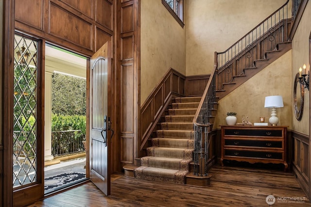 2045 250th Pl NE, Sammamish, WA 98074 - foyer entrance with a decorative wall, dark wood-style floors, stairs, and wainscoting