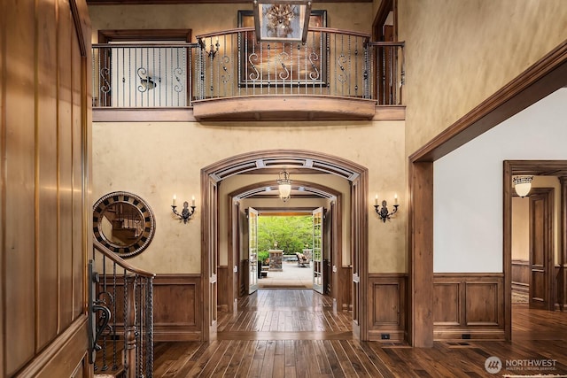 2045 250th Pl NE, Sammamish, WA 98074 - entryway with dark wood-style flooring, wainscoting, arched walkways, and a towering ceiling