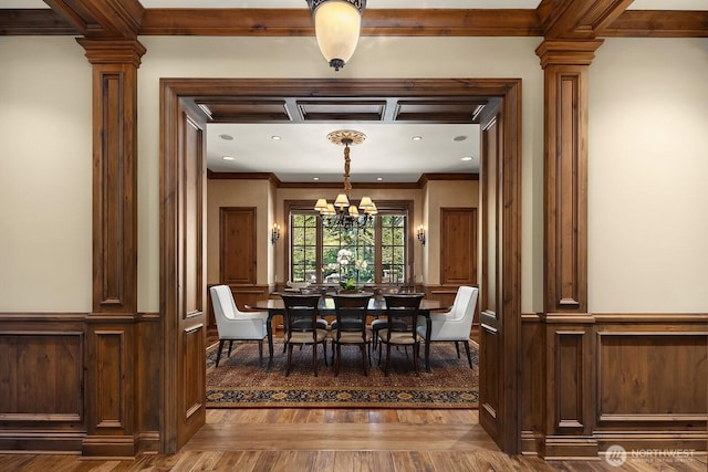 2045 250th Pl NE, Sammamish, WA 98074 - dining space with a chandelier, ornate columns, dark wood-style floors, crown molding, and a decorative wall
