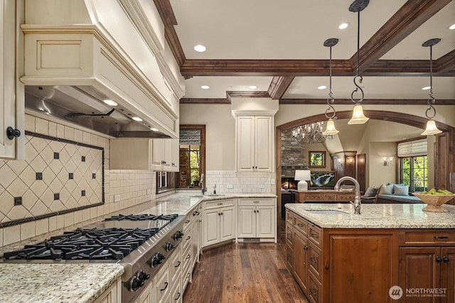 2045 250th Pl NE, Sammamish, WA 98074 - kitchen with custom range hood, stainless steel gas cooktop, a sink, dark wood-type flooring, and crown molding