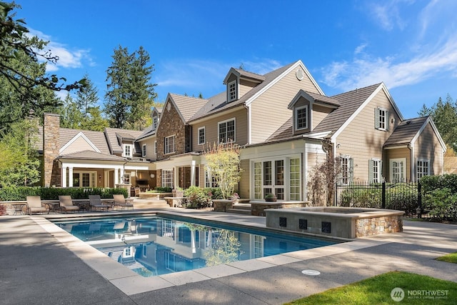 2045 250th Pl NE, Sammamish, WA 98074 - back of house with a jacuzzi, a patio area, french doors, fence, and an outdoor pool