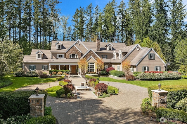 2045 250th Pl NE, Sammamish, WA 98074 - view of front of property with stone siding, a front yard, and curved driveway