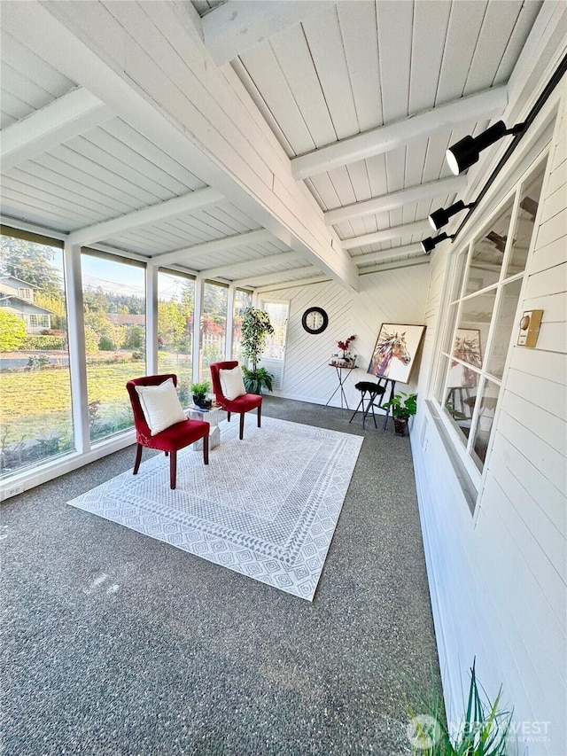 sunroom featuring beamed ceiling