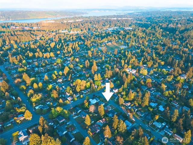 aerial view of property and surrounding area with a forest