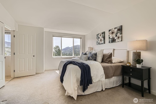 bedroom with light carpet, baseboards, and lofted ceiling