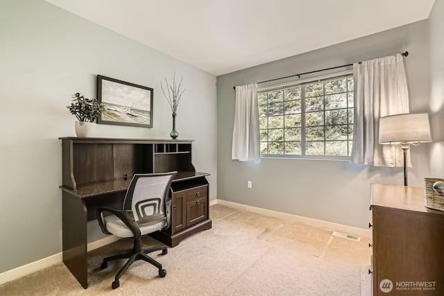 office space with baseboards and light colored carpet