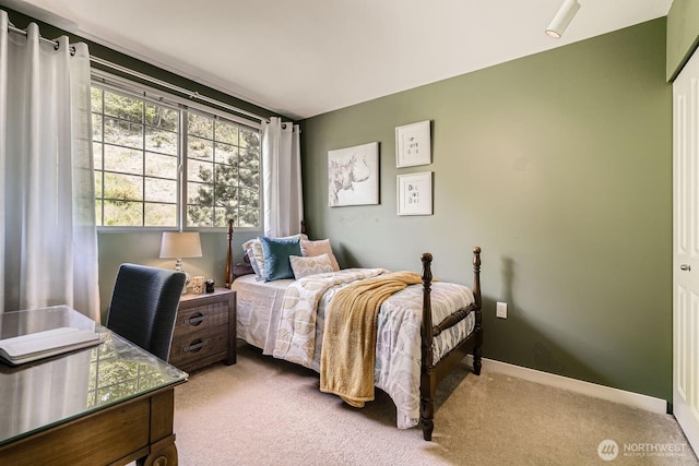 carpeted bedroom featuring baseboards
