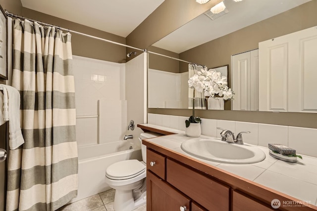 bathroom with toilet, vanity, shower / bath combo, and tile patterned floors