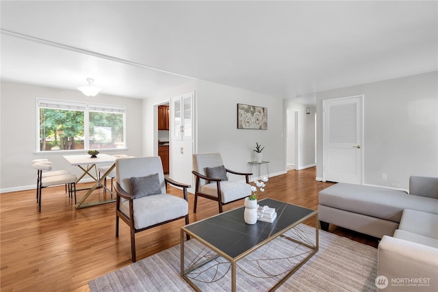 living room featuring light wood-style floors and baseboards