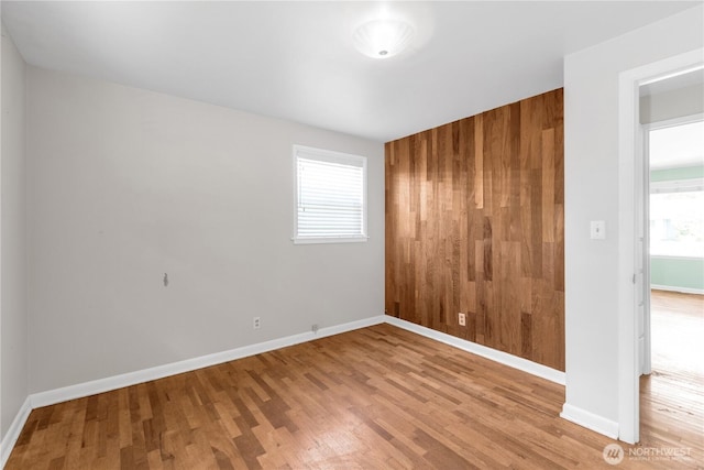 unfurnished room featuring wood finished floors and baseboards