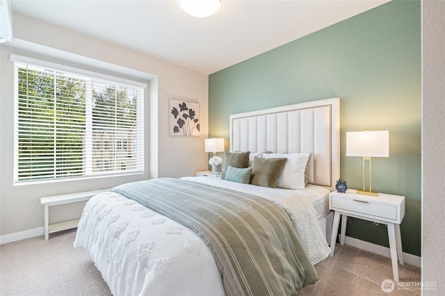 bedroom featuring carpet flooring, a wall mounted air conditioner, and baseboards