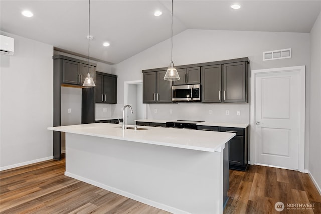 21 E Compass Ln, Allyn, WA 98524 - kitchen featuring a sink, stainless steel microwave, dark wood-style flooring, light countertops, and recessed lighting