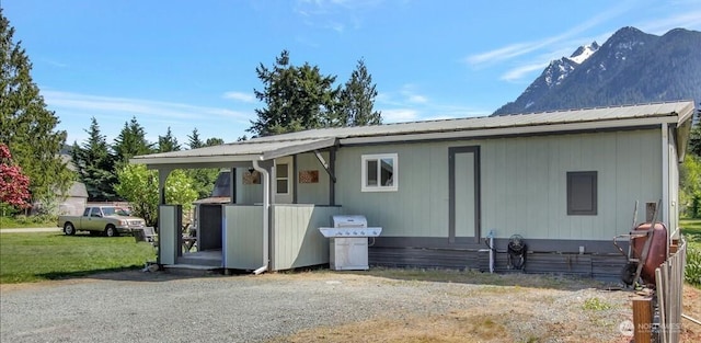 exterior space with metal roof and a mountain view