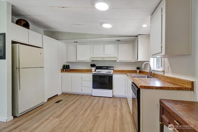 kitchen with freestanding refrigerator, light wood-style floors, a sink, and electric range